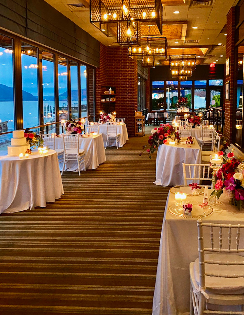 View of the riverside terrace set for a wedding reception